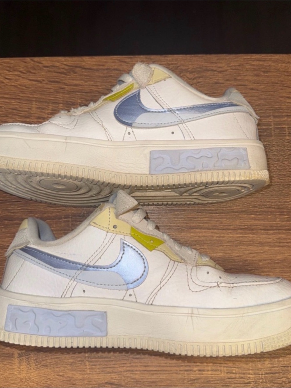 Nike White Sneakers with Light Blue Swoosh and Yellow Accents